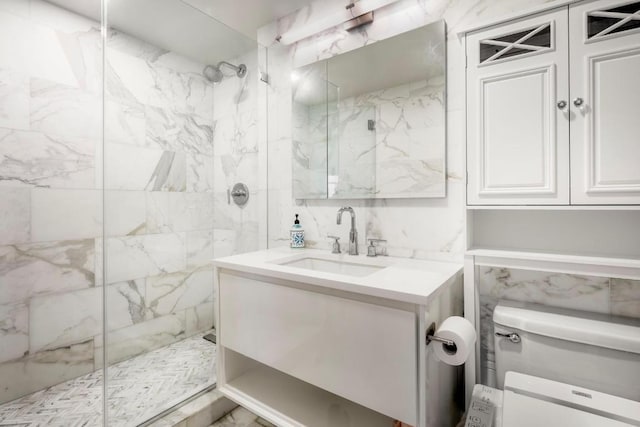 full bath with tile walls, vanity, and a marble finish shower