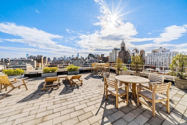 view of patio / terrace featuring outdoor dining area and a city view