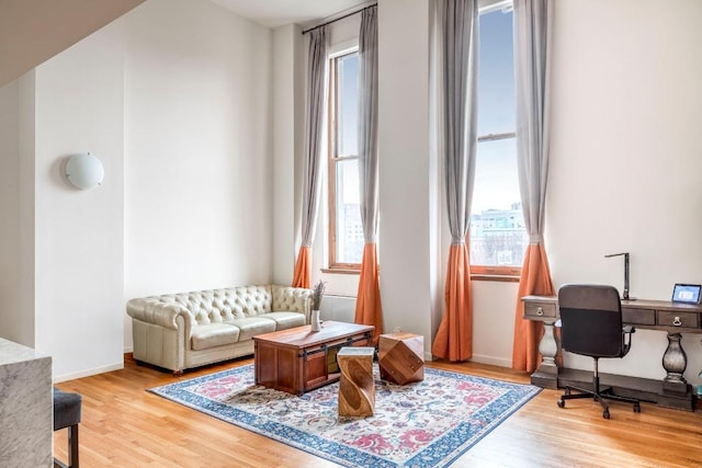 interior space with baseboards and wood finished floors