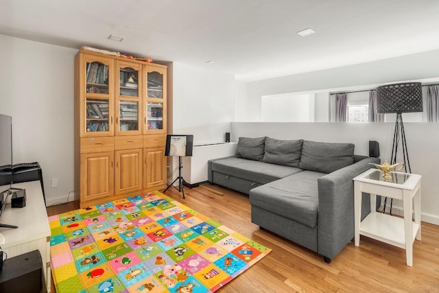 living room featuring light wood-style floors and baseboards