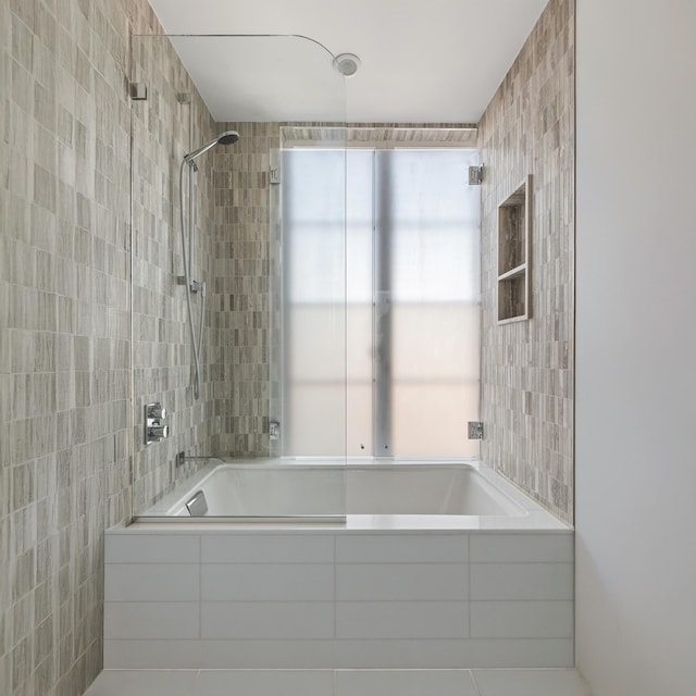 full bath with tiled shower / bath, tile walls, and tile patterned flooring