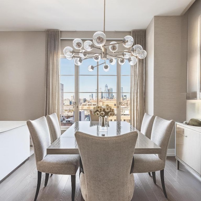 dining room with hardwood / wood-style floors, french doors, and a notable chandelier