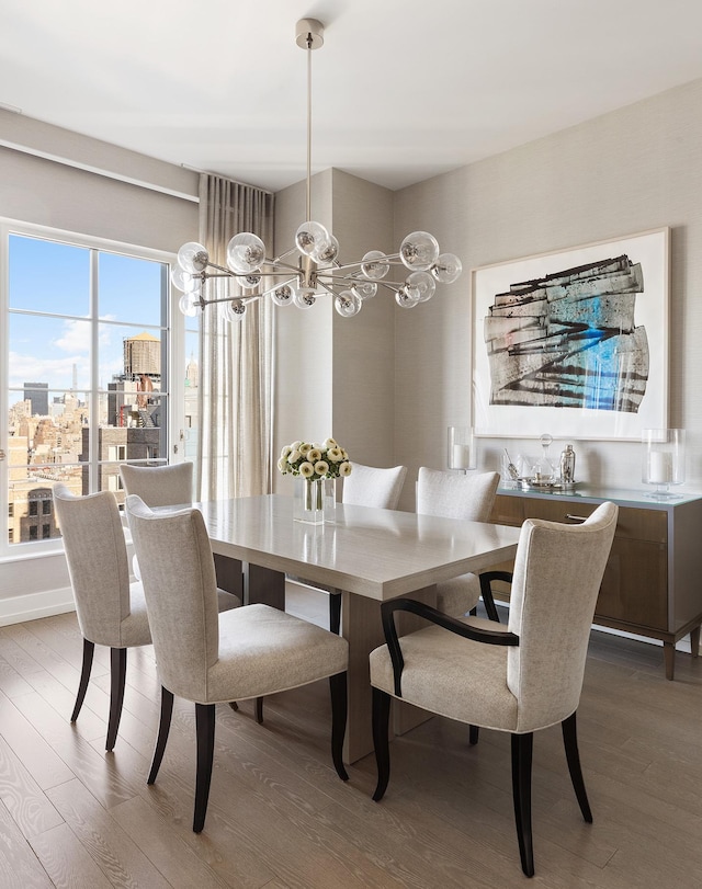 dining space featuring a chandelier and wood finished floors