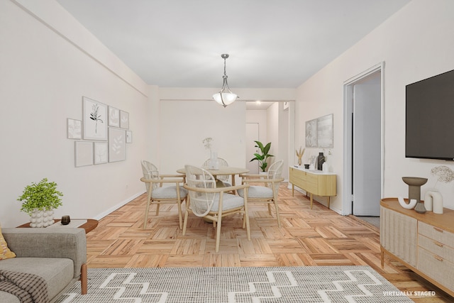 dining space with light parquet floors