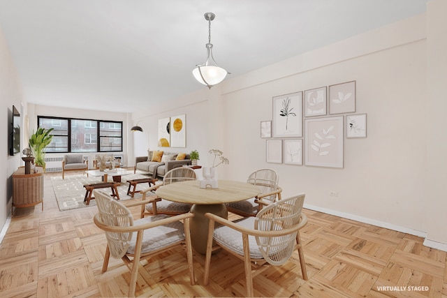 dining space featuring light parquet flooring