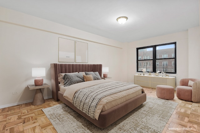 bedroom with light parquet flooring