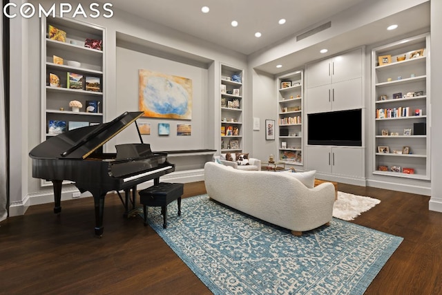 living area with dark hardwood / wood-style floors and built in shelves