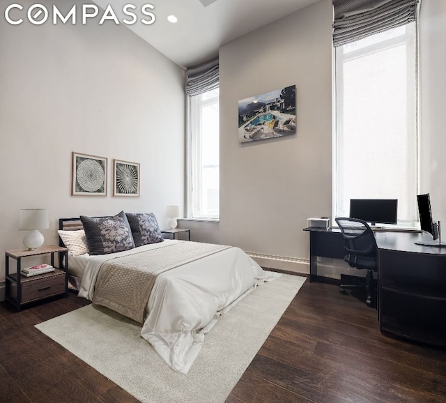 bedroom with dark hardwood / wood-style flooring