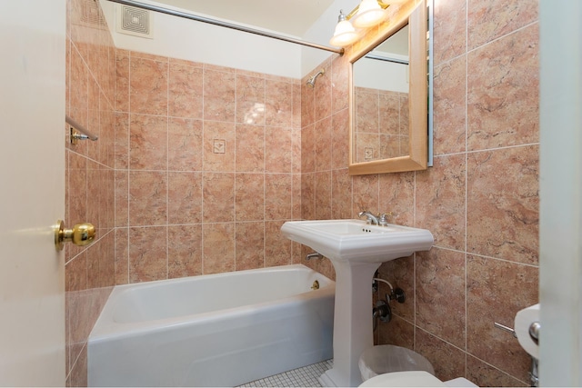 135 Ocean Pkwy Unit 1U, New York City, NY 11218 - full bath with toilet, tile walls, tile patterned flooring, and tub / shower combination