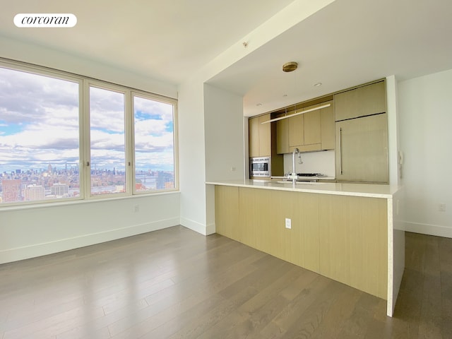 388 Bridge St Unit 43H, New York City, NY 11201 - kitchen with dark wood-style floors, visible vents, a peninsula, light countertops, and modern cabinets