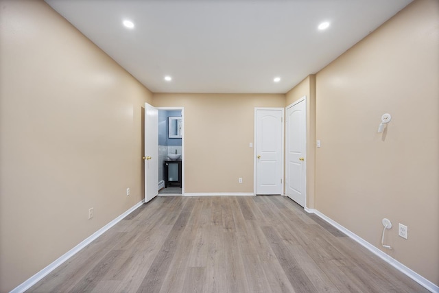 7931 Seaview Ave Unit B1, New York City, NY 11236 - unfurnished bedroom featuring light wood-style flooring, baseboards, recessed lighting, and ensuite bathroom