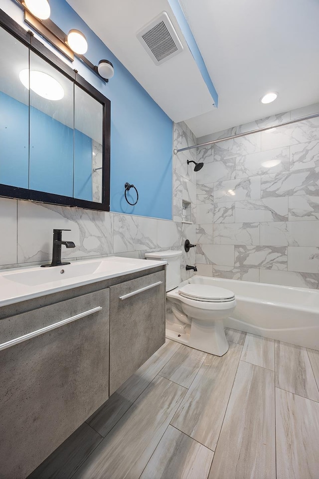 7931 Seaview Ave Unit B1, New York City, NY 11236 - bathroom featuring toilet, washtub / shower combination, vanity, tile walls, and recessed lighting