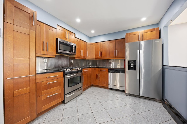 7931 Seaview Ave Unit B1, New York City, NY 11236 - kitchen with appliances with stainless steel finishes, dark countertops, backsplash, brown cabinets, and recessed lighting