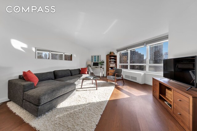 living room featuring radiator heating unit and hardwood / wood-style floors