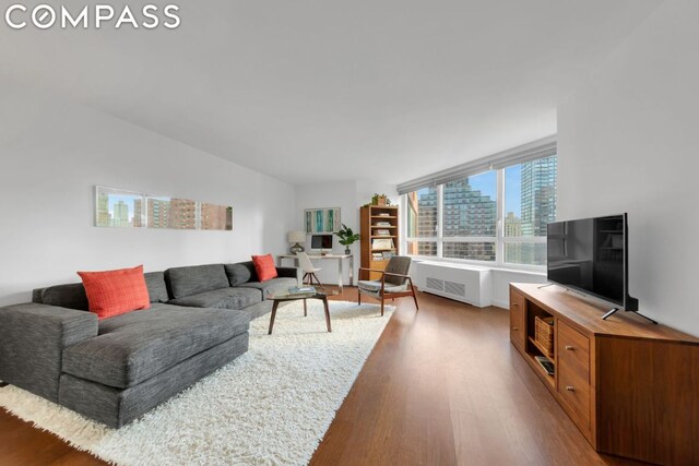 living room featuring radiator heating unit and hardwood / wood-style floors