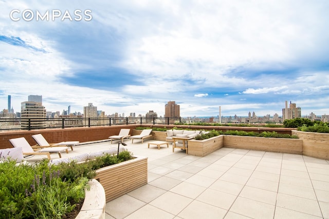 view of patio featuring an outdoor living space and a city view