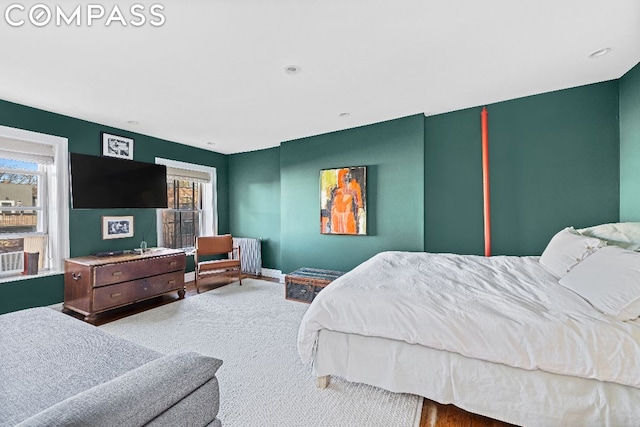 bedroom with radiator and carpet flooring