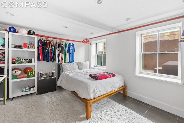 bedroom with beam ceiling