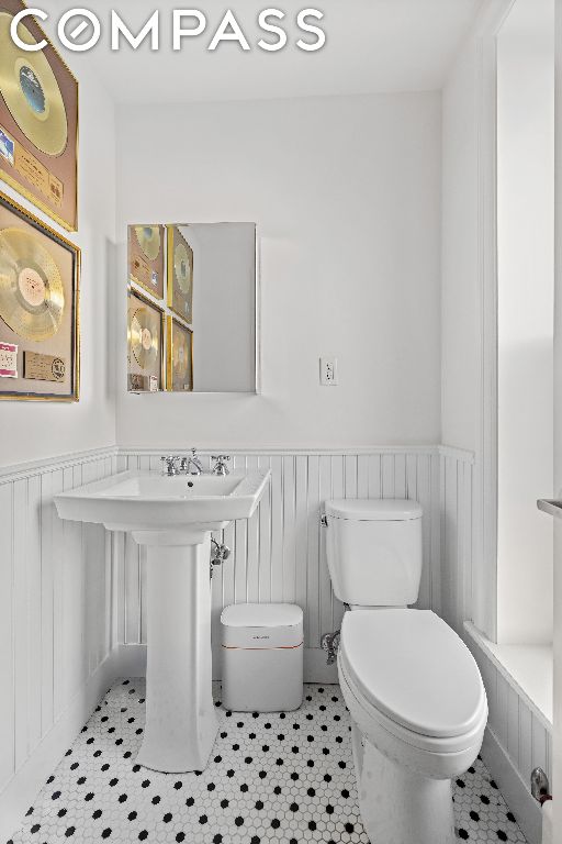 bathroom featuring tile patterned floors and toilet