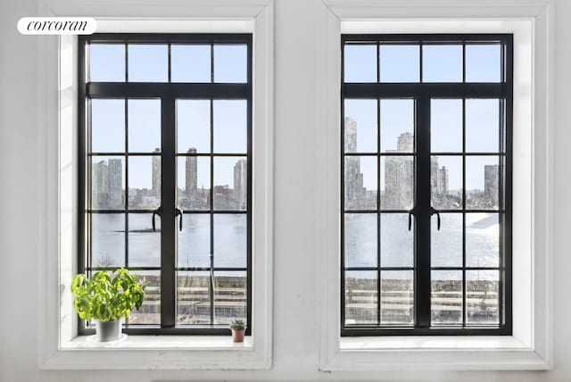 entryway featuring a view of city, french doors, and a healthy amount of sunlight