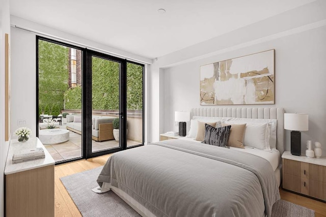 bedroom with light wood-style flooring and access to outside