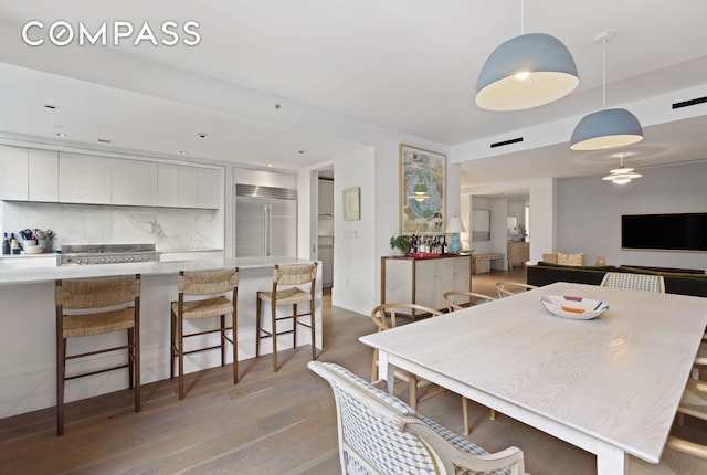 dining space featuring light wood-style floors