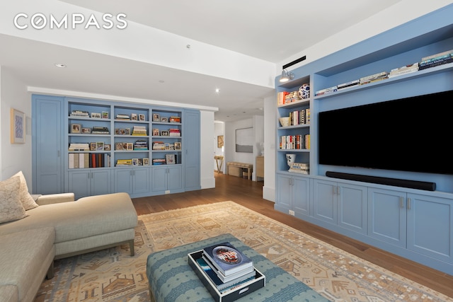 living area featuring recessed lighting, light wood-type flooring, and built in features