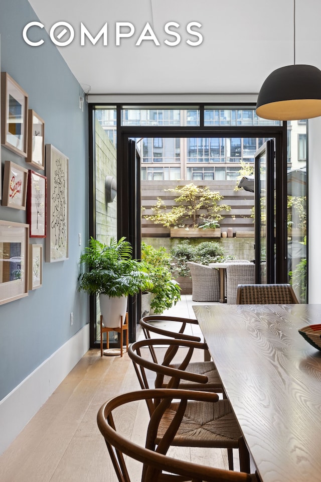 dining area with expansive windows and baseboards