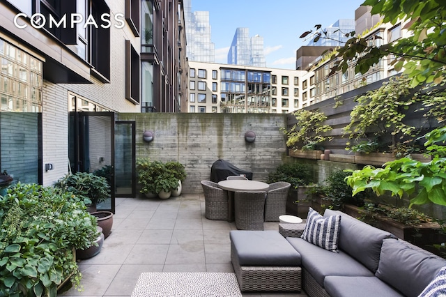 view of patio / terrace featuring an outdoor living space and a city view