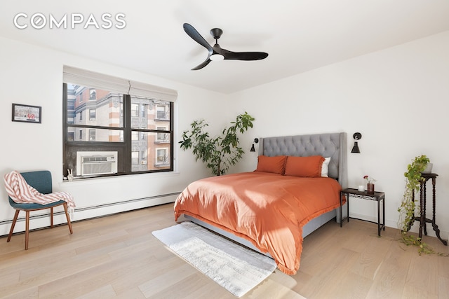 bedroom with ceiling fan, cooling unit, baseboard heating, and wood finished floors