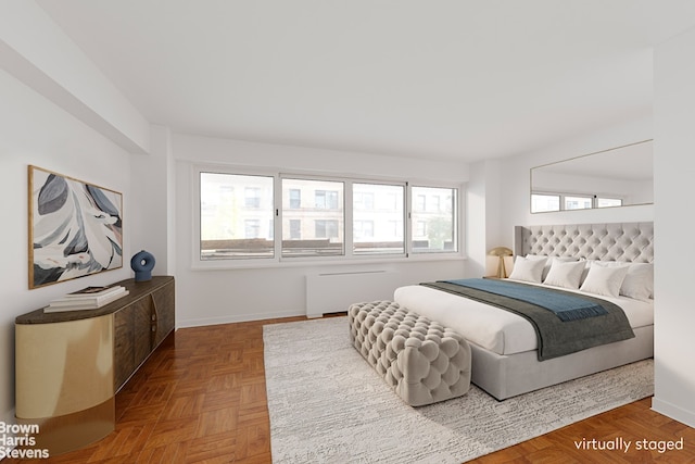 bedroom with parquet floors and radiator