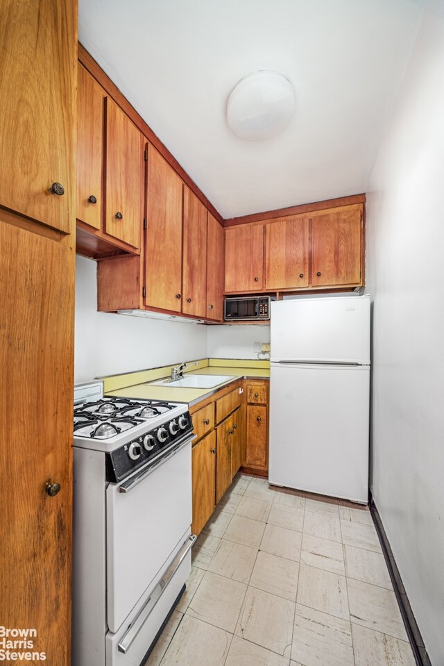 kitchen with sink and white appliances