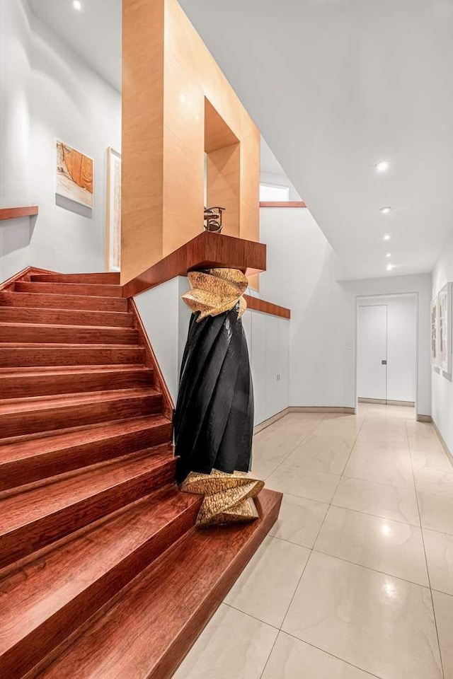 stairs featuring baseboards and marble finish floor