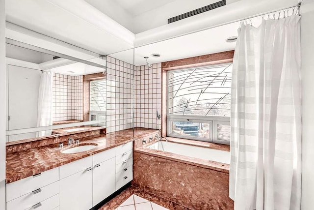 bathroom with shower / tub combo with curtain, vanity, and tile patterned flooring