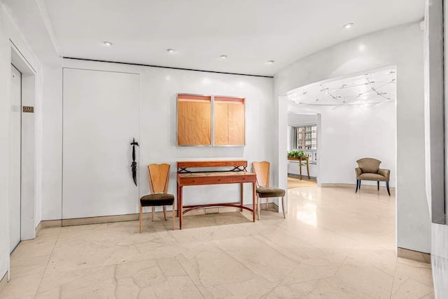 sitting room with recessed lighting and marble finish floor