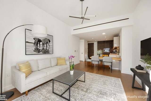 202 Broome St Unit 7L, New York City, NY 10002 - living room with wood finished floors, baseboards, recessed lighting, and a ceiling fan