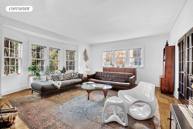 living area with crown molding, visible vents, and baseboards