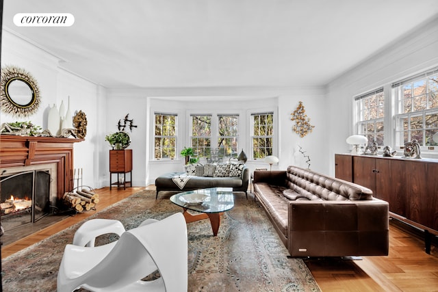 living area with plenty of natural light, a fireplace with flush hearth, visible vents, and crown molding