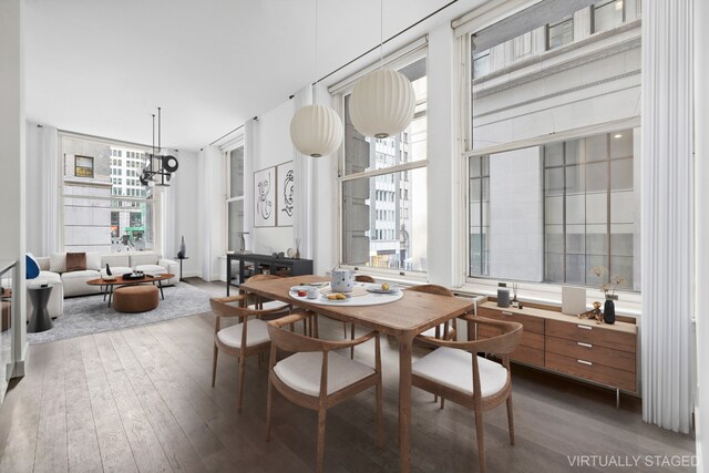 dining area featuring hardwood / wood-style flooring and a notable chandelier