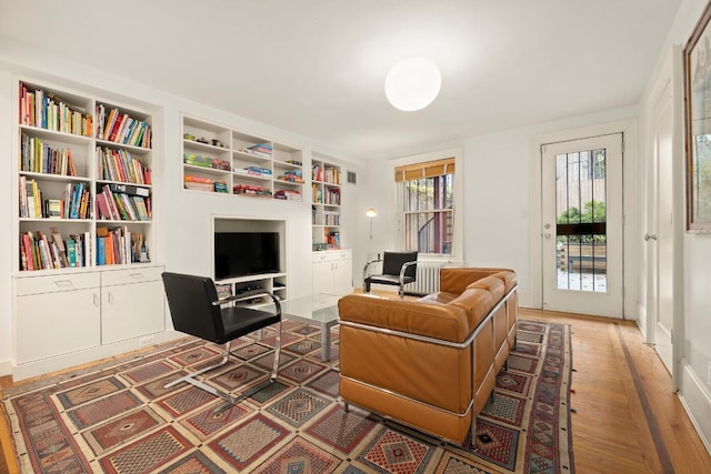 interior space with dark hardwood / wood-style flooring and built in shelves