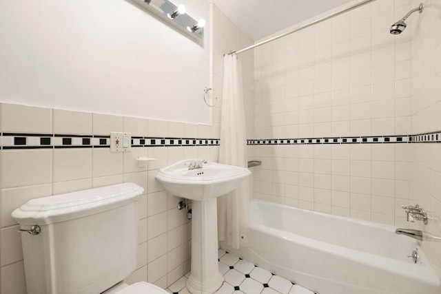 bathroom with toilet, tile walls, and shower / bath combo