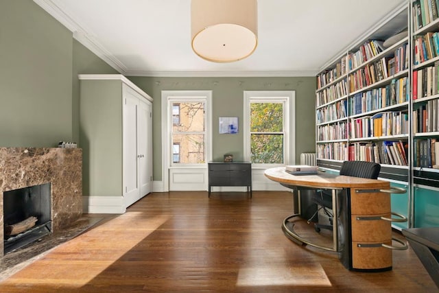 living area featuring dark hardwood / wood-style floors, crown molding, and a fireplace