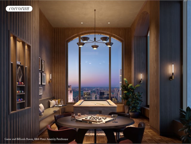 dining space featuring parquet floors, an inviting chandelier, and wood walls