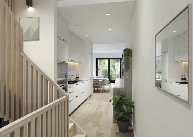 hall featuring light wood-type flooring and sink