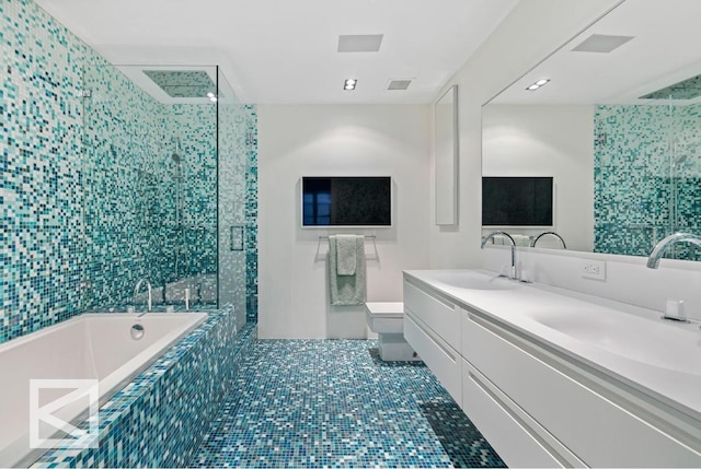 full bathroom featuring toilet, vanity, tile patterned flooring, and shower with separate bathtub