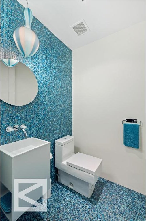 bathroom with sink, toilet, and tile patterned flooring