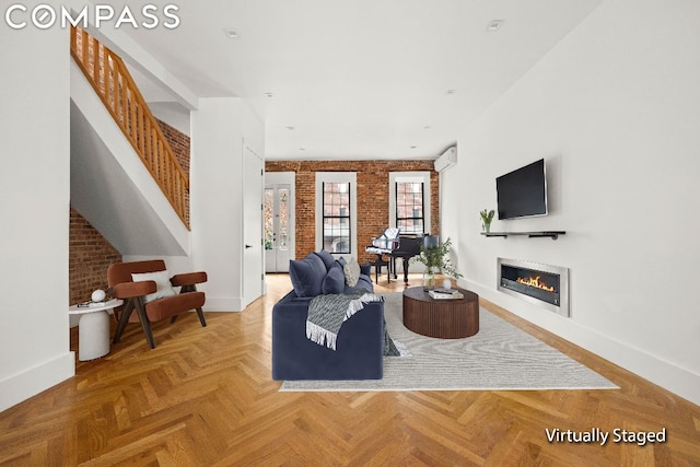 living room featuring brick wall and parquet floors