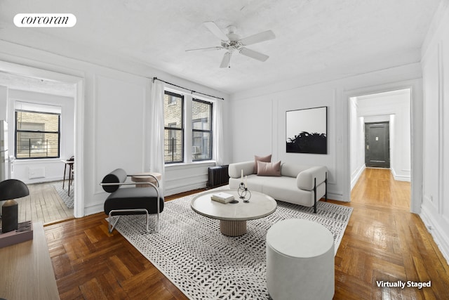 living room with radiator, parquet floors, and ceiling fan