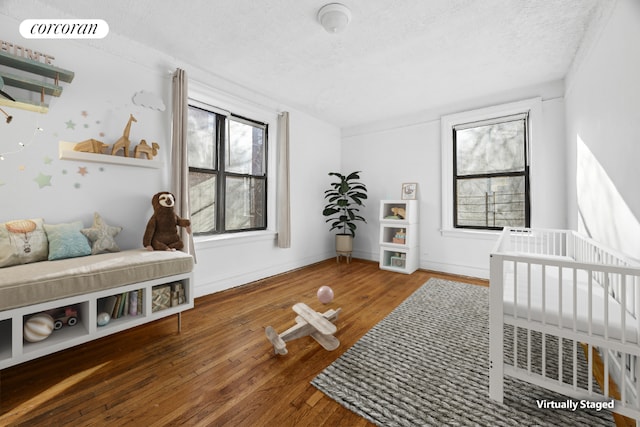 bedroom with hardwood / wood-style flooring and a textured ceiling