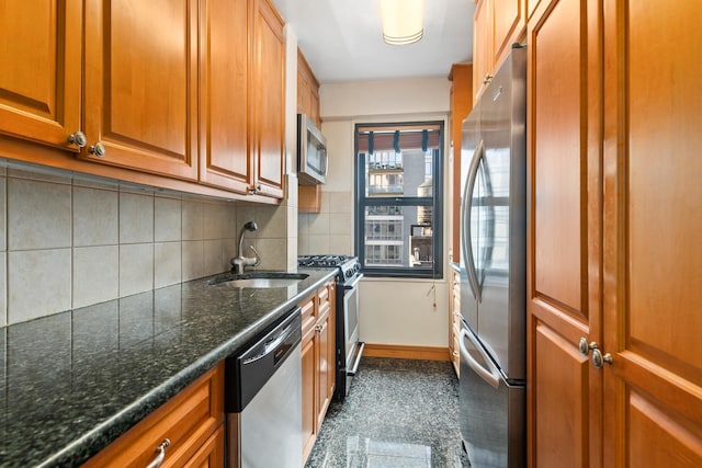 kitchen featuring stainless steel appliances, decorative backsplash, brown cabinetry, a sink, and baseboards